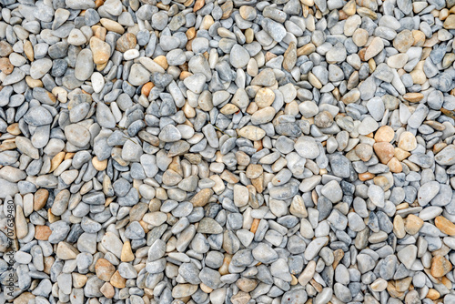 White and gray stone pebbles background texture close-up