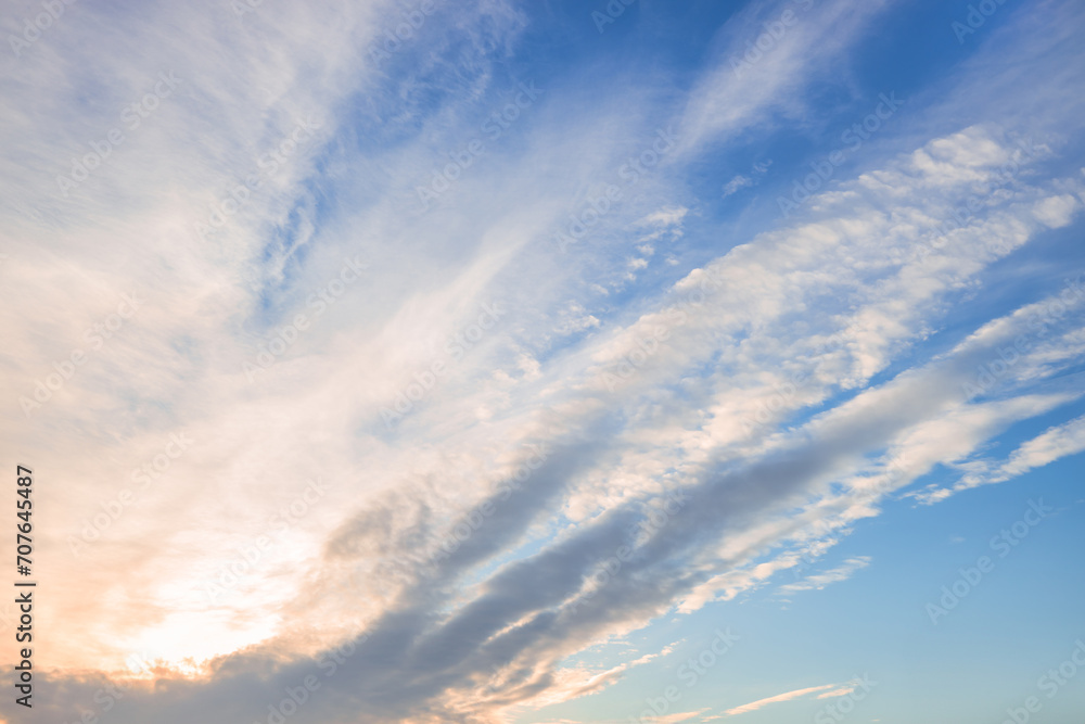 Obraz premium A beautiful sky tinted by the sun leaving vibrant shades of gold, pink, blue and multicolored. Clouds in the twilight evening and morning sky. Cloudy sky background in the evening and during the day.