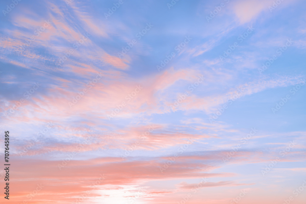 A beautiful sky tinted by the sun leaving vibrant shades of gold, pink, blue and multicolored. Clouds in the twilight evening and morning sky. Cloudy sky background in the evening and during the day.