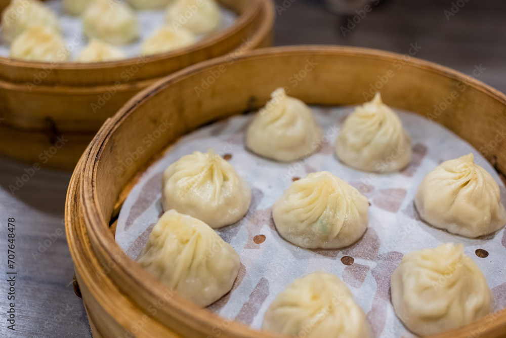 Steamed xiaolongbao served in a traditional steaming basket Steamed xiaolongbao served in a traditional steaming basket