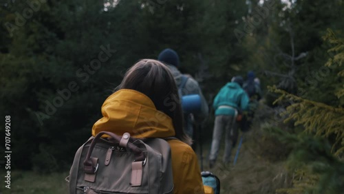 Wallpaper Mural Caucasian couple stands among the trees in forest, looks at camera. Tourist family during hike or trek in mountains on vacation. Group of multiethnic hikers walking in background. Outdoor enthusiasts. Torontodigital.ca