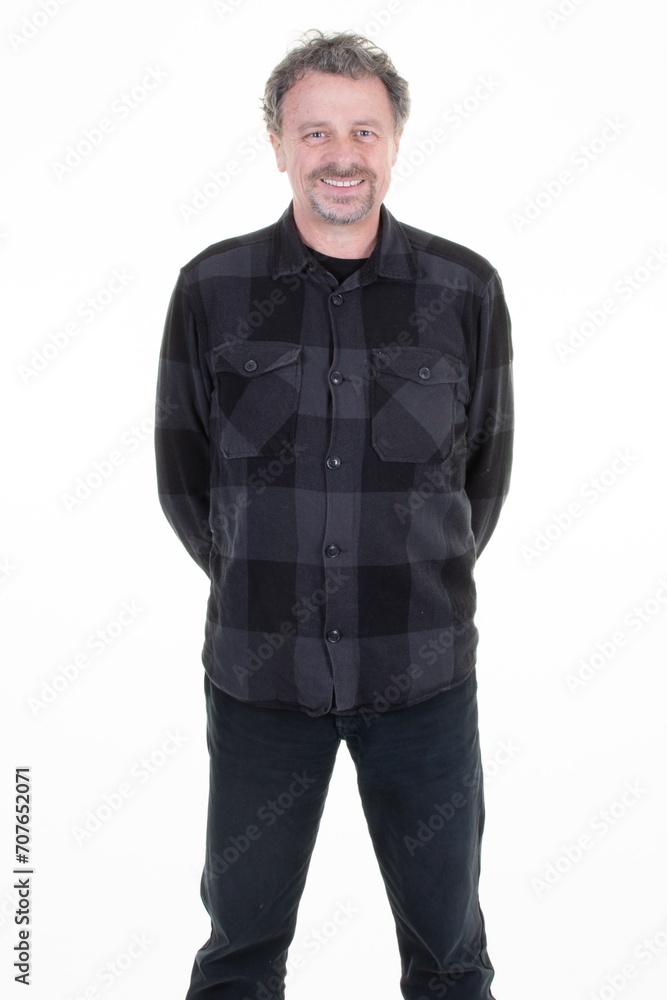 Portrait of confident middle aged man wearing plaid shirt with arms crossed back standing on white background Portrait of confident middle aged man wearing plaid shirt with arms crossed back standing on white background
