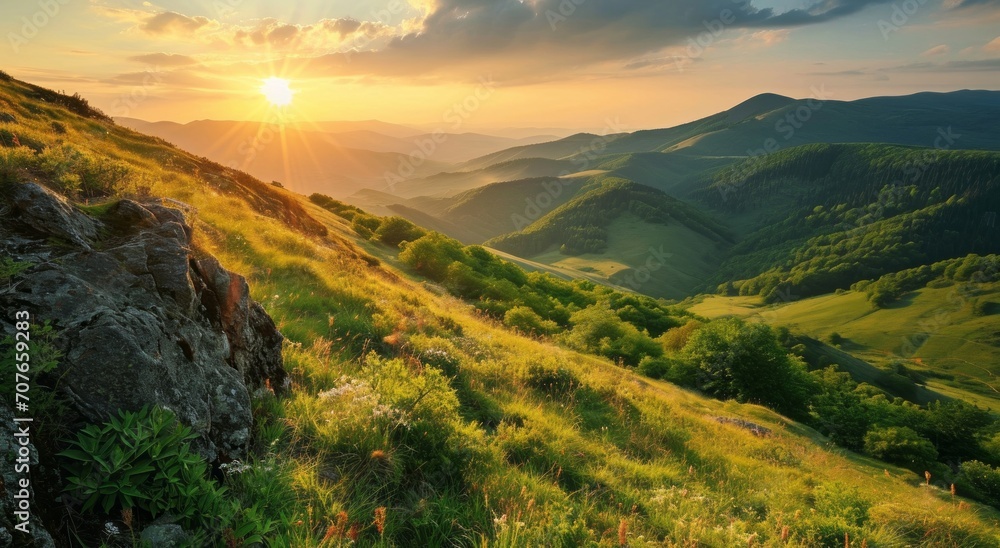 Sunrise over lush green hills with light rays piercing through the valleys, highlighting the contours of the landscape.