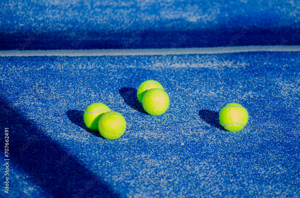 selective focus, balls on a blue paddle tennis court