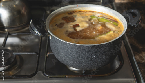 Cooking soup on a gas stove.