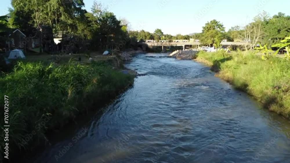 Fly slowly over the forest and river in the morning. There is a beautiful river, sky and natural landscape. Fly slowly over the forest and river in the morning. There is a beautiful river, sky and natural landscape.