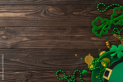 Leprechaun's Legacy: top view St. Patrick's Day essentials – leprechaun's hat, themed glasses, lucky horseshoe, gold coins, trefoils, confetti, beads on wooden surface. Set mood for joyous celebration