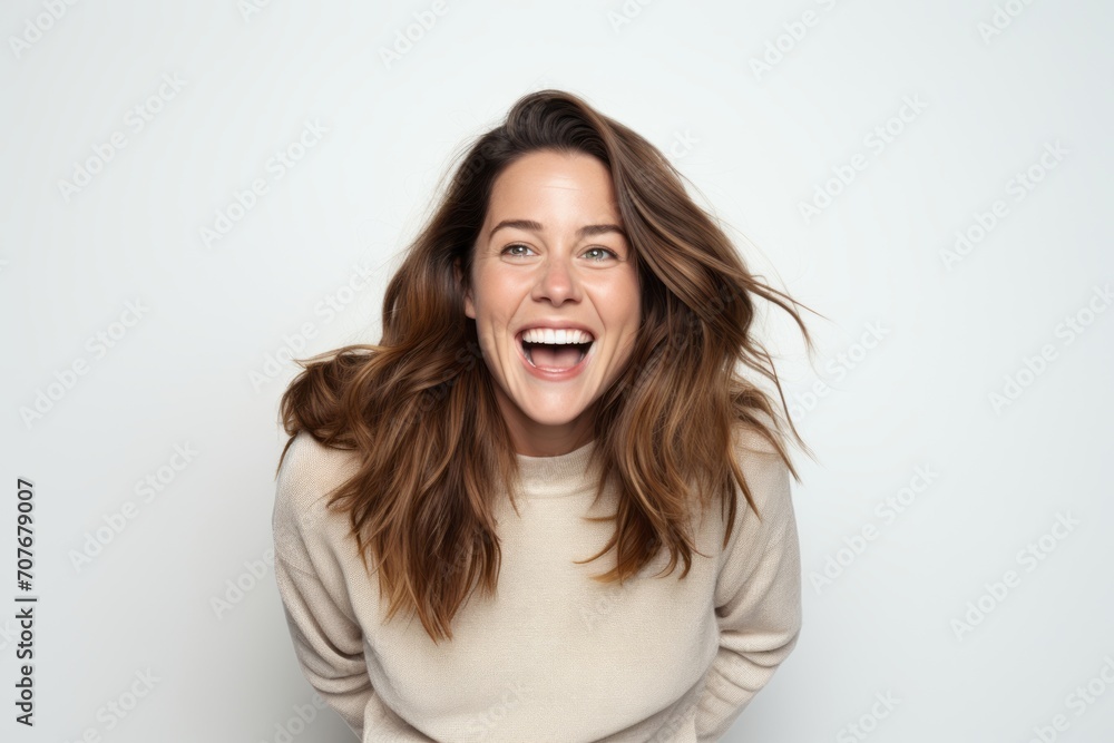 Portrait of a happy young woman laughing and looking at the camera Portrait of a happy young woman laughing and looking at the camera
