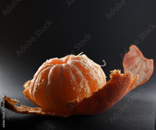 peeled mandarin on black background