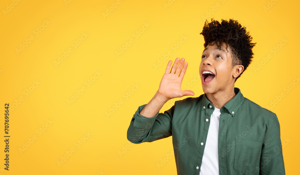 Excited young black guy screaming towards copy space Excited young black guy screaming towards copy space