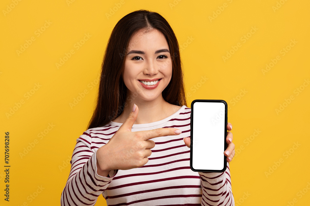Pretty young asian woman showing phone with white screen Pretty young asian woman showing phone with white screen