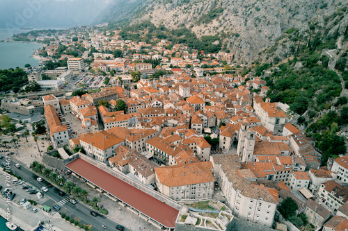Embankment of the ancient town of Kotor at the foot of the mountains. Montenegro. Aerial view