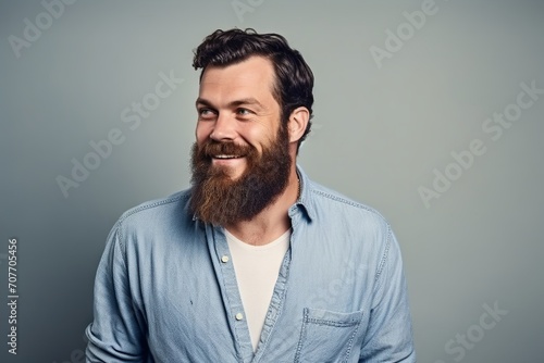 Portrait of a bearded hipster man in a blue shirt. © Inigo