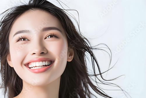 Young Asian woman close up portrait. Model woman laughing and smiling. Healthy face skin care beauty, skincare cosmetics, dental.
