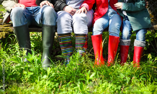 Happy family wearing colorful rain boots