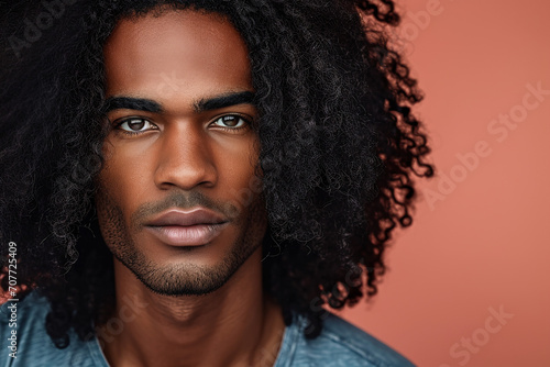 Dark skin man with curly hair. 