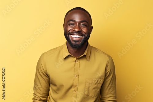 Portrait of a happy african american man on yellow background
