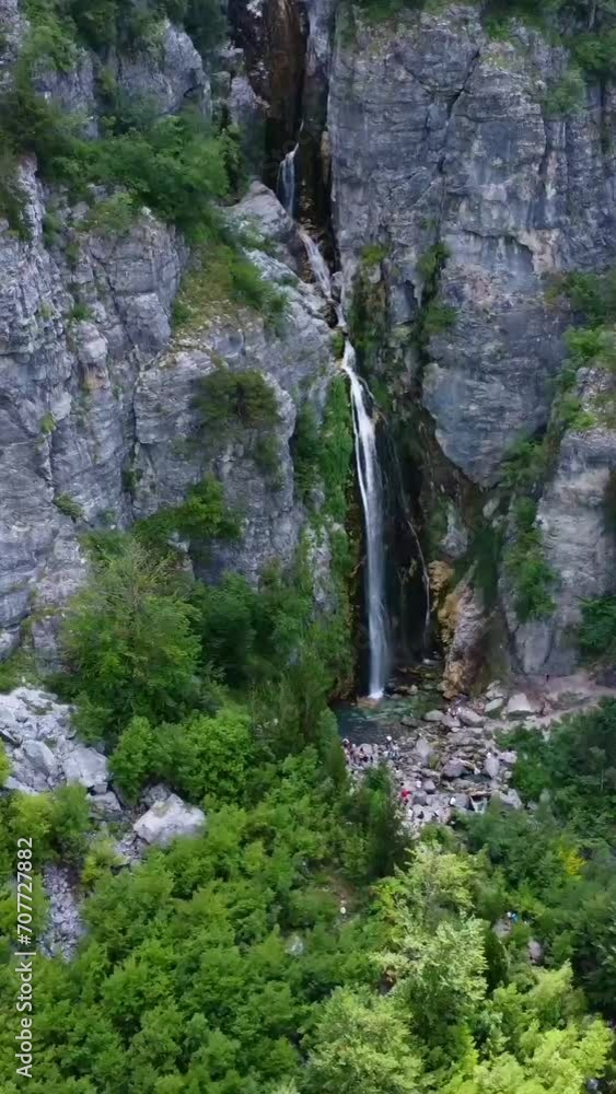 Aerial drone view of the waterfall in Theth national park, Albania. Zoom towards the waterfall Aerial drone view of the waterfall in Theth national park, Albania. Zoom towards the waterfall