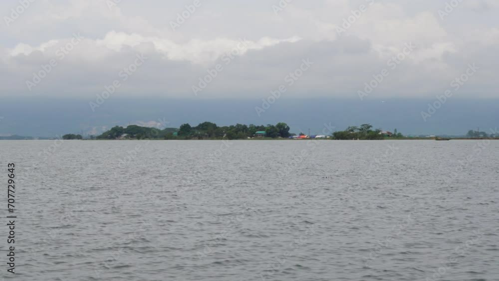 A view of the marsh water from a moving boat. Scenery of wetland water in Haor, Sunamganj, Bangladesh. A view of the marsh water from a moving boat. Scenery of wetland water in Haor, Sunamganj, Bangladesh.
