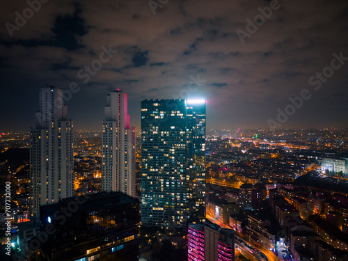 Istanbul's glass and concrete skyscrapers, home to offices, hotels, and residential complexes at night. Aerial drone view
