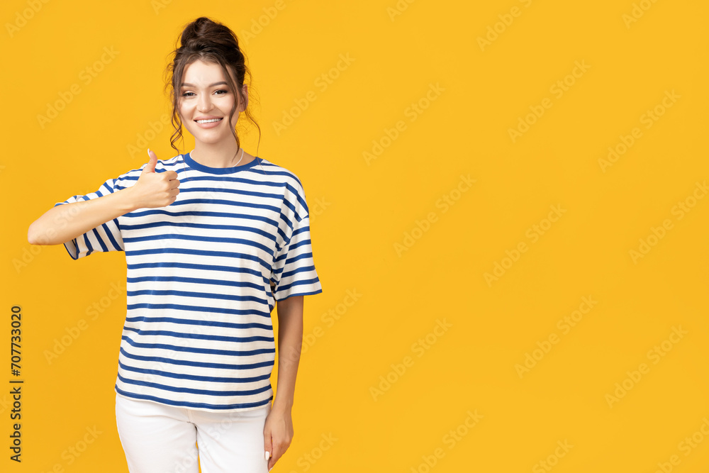 Attractive young girl posing on a yellow background Attractive young girl posing on a yellow background