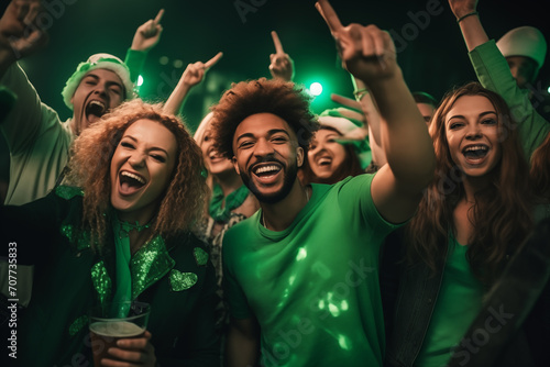 St Patrick's day concept - young people parting and dancing in a pub