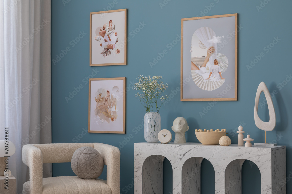 Φωτογραφία Aesthetic composition of cozy living room with mock up poster frame, marble console, stylish armchair, round pillow, vase with flowers, coffee table, books, candle and accessories