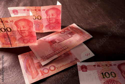 Chinese yuan in counter light against a dark background. Concept of finance and economics. Selective focus. photo