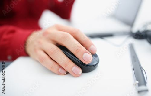 Male hand used computer mose holding in arm. Search for information for earnings in the Internet