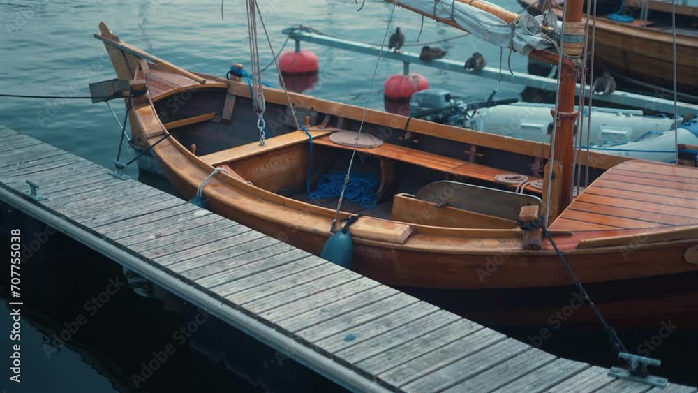 Moored wooden boat in the marina at sunny summer day Moored wooden boat in the marina at sunny summer day