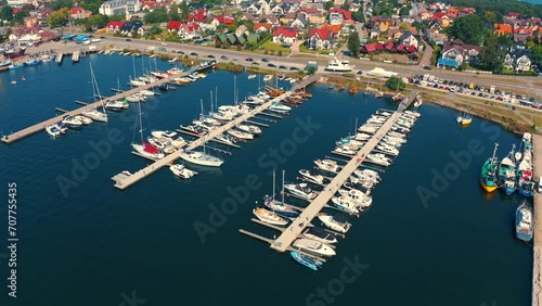 Drone flying arount the marina and moored yachts, boats and motoroboats in Poland photo