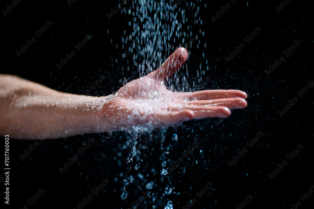 Closeup shot of a human's hand with water flowing onto it