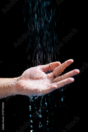 Closeup shot of a human s hand with water flowing onto it