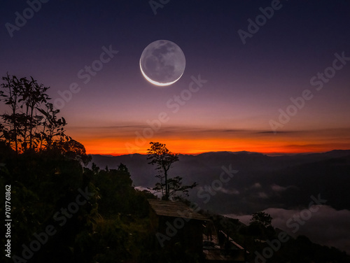 Morning light with the moon on the horizon at Baan Thiyaphe, Sop Moei District, Mae Hong Son Province, Thailand photo