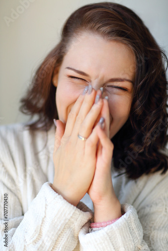 Close up portrait of young funny brunette girl laughing hard on some joke