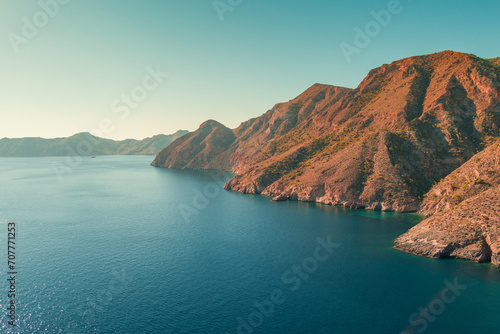 Mountain landscape with rocky seascape. Aerial panoramic view to the west from El Portus and Morena beach. Murcia, Spain