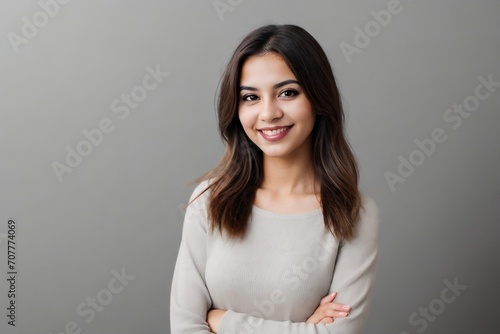 Beautiful Latin American woman standing against a grey background with copy space.