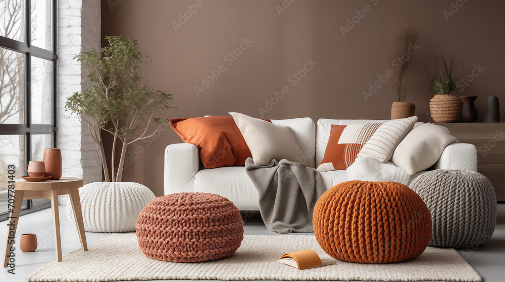 Obraz na płótnie Scandinavian, hygge style home interior design of modern living room, Knitted pouf near white fabric sofa with blanket and terra cotta pillows, Ai generated image w salonie