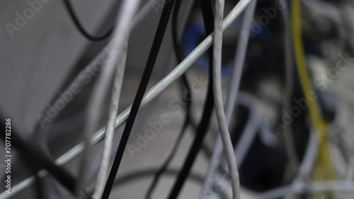 many wires are haphazardly connected to the outlet, to the router and to other devices. Clutter in the workplace. Electrical cables, internet cables and various wires were laid out at random. photo