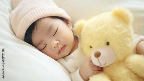 Newborn Asian baby girl sleeping with a teddy bear. Generative AI.