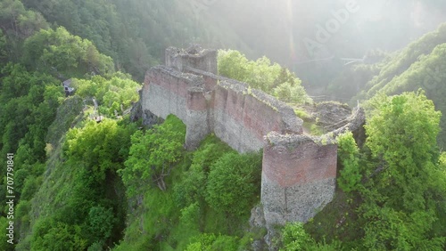 Poenari fortress in Romania. Aerial 4k video with this amazing fortress on top of a peak hill from Fagaras Mountains, the place where Vlad Dracula lived. Travel to Romania landmarks. Sunset sky.