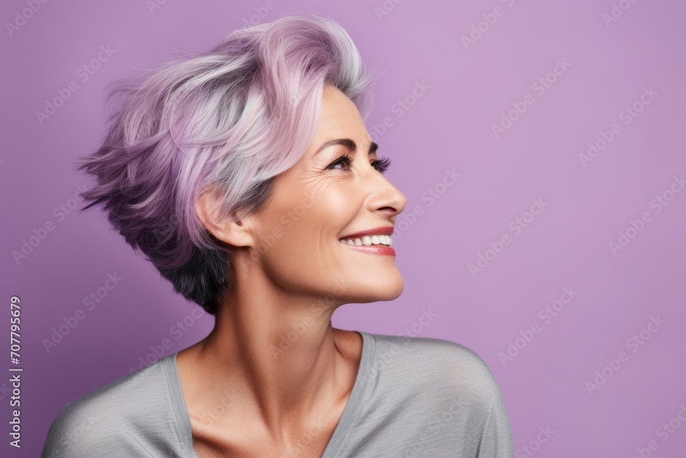 Portrait of a beautiful smiling woman with pink hair on purple background Portrait of a beautiful smiling woman with pink hair on purple background