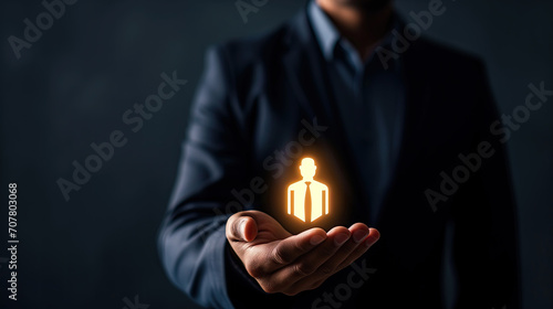 businessman holding a icon for an employee, human ressource and marketing concept