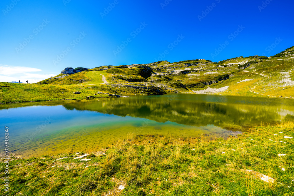 Fototapeta premium View of the surrounding landscape and Lake Augstsee at the Loseralm near Altaussee in the Salzkammergut in Austria. Nature with panoramic views of the mountains on the Loser Alm in Styria. 