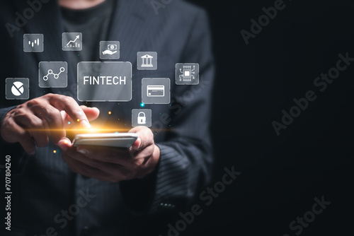 Fintech (financial technology) and digital money concept. Businessman use mobile smart phone with digital finance icons for digital banking, internet payment, online shopping, financial technology.