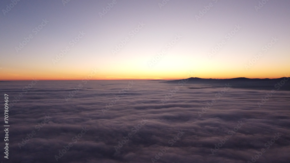 Sunset above clouds