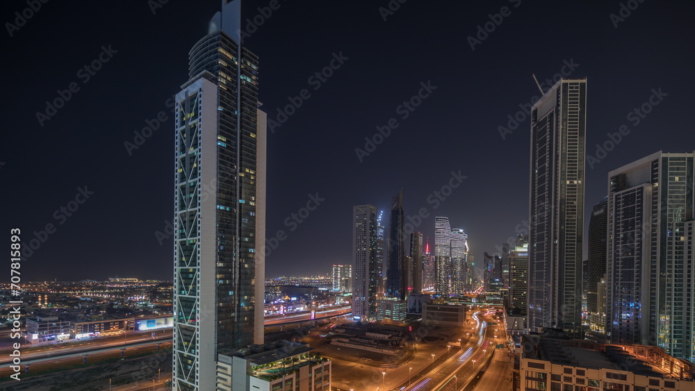 Fototapeta premium Aerial view of Dubai Downtown skyline with many towers night timelapse.
