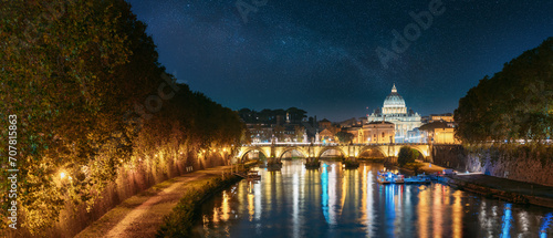 Rome, Italy. Papal Basilica Of St. Peter In The Vatican And Aelian Bridge In Evening Night Illuminations. Panoramic View milky way, night star sky, cosmos, space,