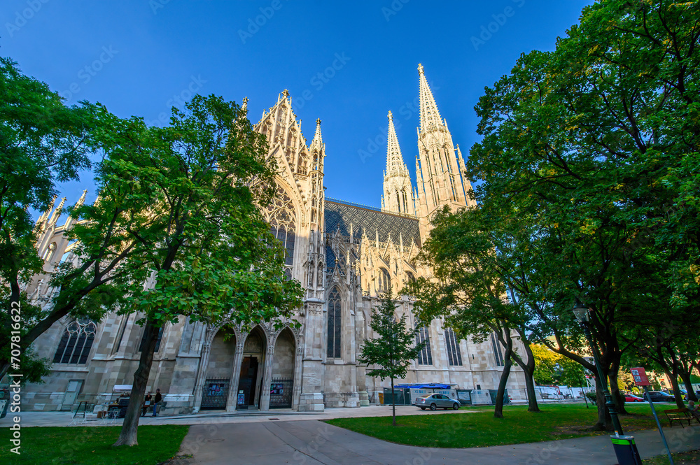 Fototapeta premium Votivkirche or Votive Church in Vienna, Austria. Famous Neo-Gothic church on Ringstrasse - second-tallest church in Wien. Church consecrated in 1879 on occasion of Imperial Couple's Silver Wedding. 