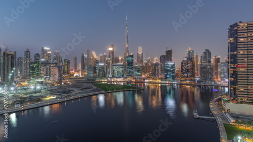 Aerial view to Dubai Business Bay and Downtown with the various skyscrapers and towers day to night timelapse © neiezhmakov